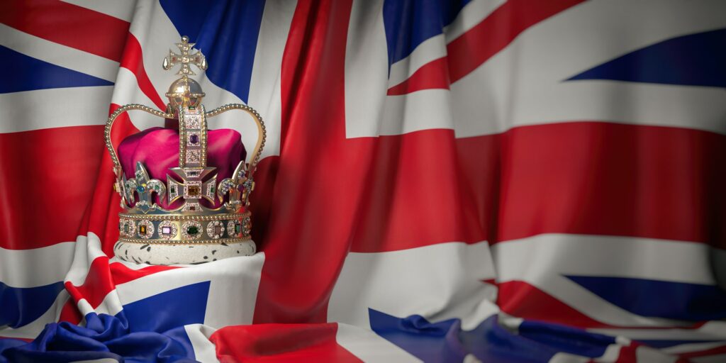Royal golden crown with jewels on british flag. Symbols of UK U