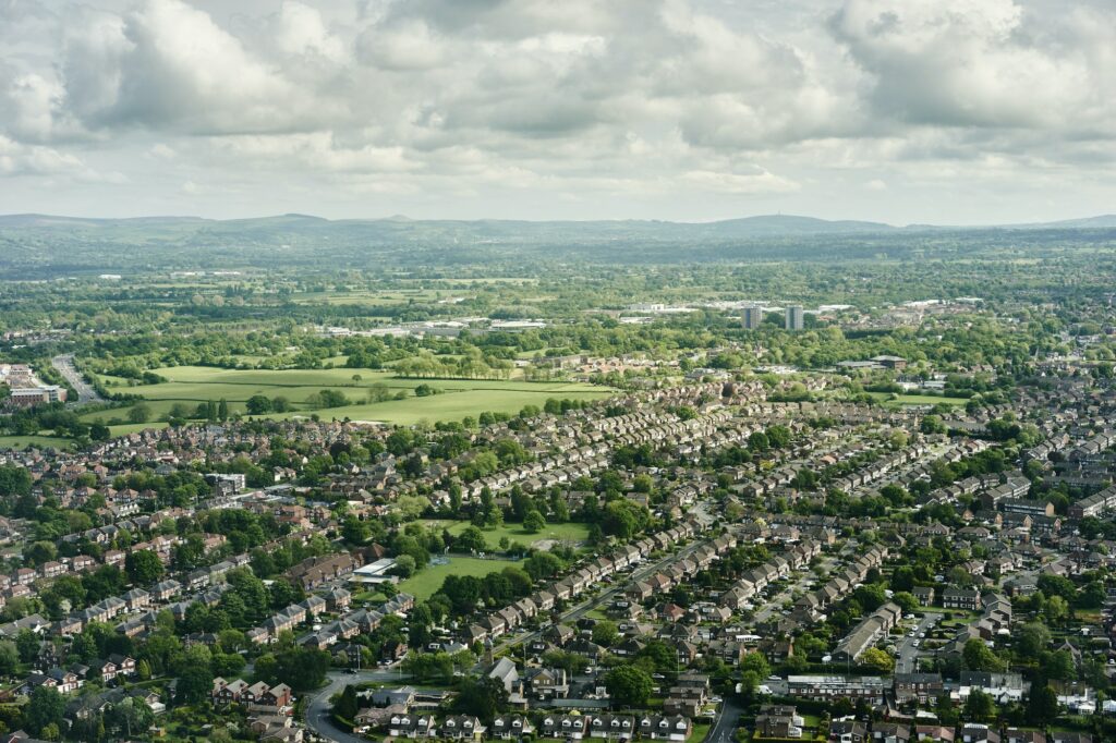 Aerial view of suburban housing and distant landscape, England, UK